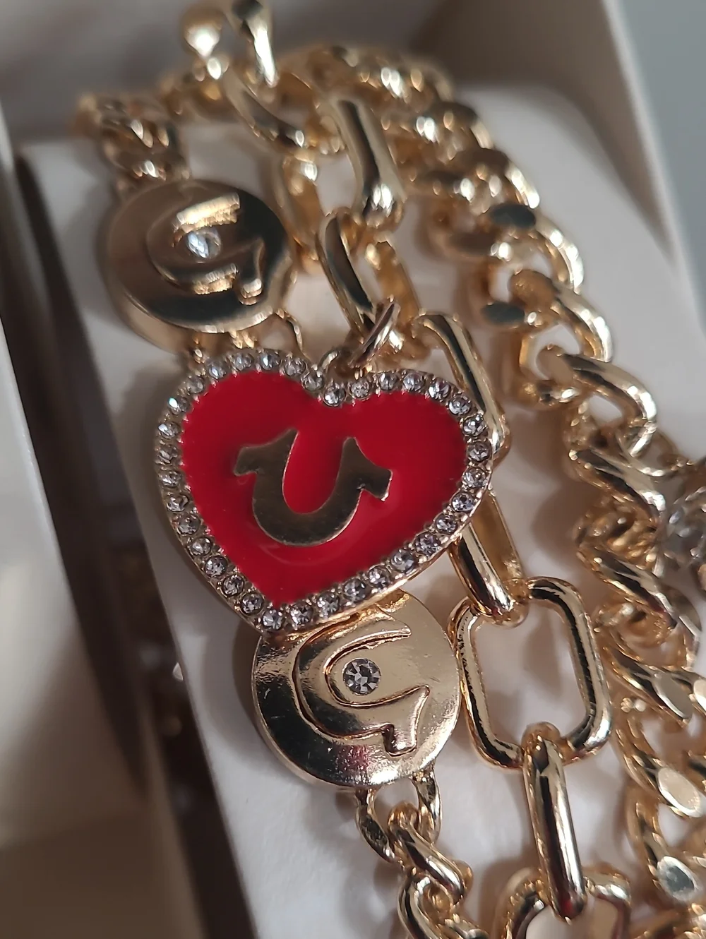 True Religion Gold-Tone Watch with Black Dial and Charm Bracelet